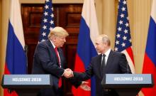 U.S. President Donald Trump and Russian President Vladimir Putin shake hands as they hold a joint news conference after their meeting in Helsinki, Finland, July 16, 2018. PHOTO BY REUTERS/Grigory Dukor