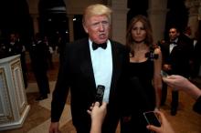 U.S. President-elect Donald Trump talks to reporters as he and his wife Melania Trump arrive for a New Year's Eve celebration with members and guests at the Mar-a-lago Club in Palm Beach, Florida, U.S., December 31, 2016. PHOTO BY REUTERS/Jonathan Erns