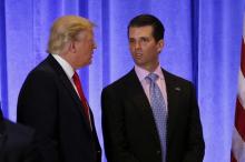 U.S. President-elect Donald Trump speaks with his son Donald Trump Jr. during a news conference in the lobby of Trump Tower in Manhattan, New York City, U.S., January 11, 2017. PHOTO BY REUTERS/Lucas Jackson