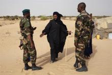 Soldiers speak with Tuareg man Alioune in the village of Tashek, outside Timbuktu