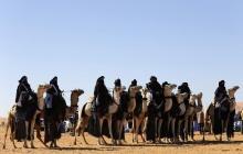 Tuareg men ride camels in the desert during the 19th Ghat Festival of Culture and Tourism, in Ghat, about 1,360 km (845 miles) south of Tripoli, December 30, 2013. PHOTO BY REUTERS/Esam Omran Al-Fetori