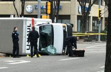 Edmonton Police investigate at the scene where a man hit pedestrians then flipped the U-Haul truck he was driving, pictured at the intersection at 107 Street and 100th Avenue in front of the Matrix Hotel in Edmonton, Alberta, Canada, October 1, 2017. PHOTO BY REUTERS/Candace Elliott