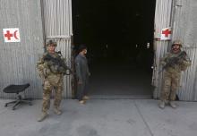 U.S. troops stand guard in front of a police medical warehouse in Kabul, August 27, 2014. PHOTO BY REUTERS/Omar Sobhani
