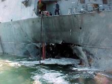 The port side damage to the guided missile destroyer USS Cole is pictured after a bomb attack during a refueling operation in the port of Aden, October 12, 2000. PHOTO BY REUTERS/Aladin Abdel Naby