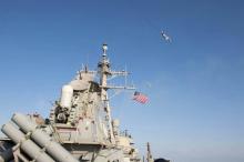 What appears to be a Russian Sukhoi SU-24 attack aircraft is flying over the U.S. guided missile destroyer USS Donald Cook in the Baltic Sea, April 12, 2016. PHOTO BY REUTERS/US Navy