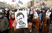 Protesters hold portraits of Ukraine's President Viktor Yanukovich during a demonstration in support of EU integration at Independence Square in Kiev