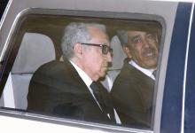 United Nations Peace Envoy for Syria Lakhdar Brahimi (L) sits in a car as he leaves a hotel in Damascus
