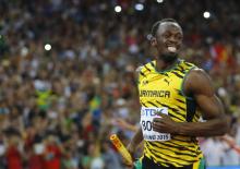 Usain Bolt of Jamaica smiles after running the anchor leg to win the men's 4 x 100 metres relay final at the 15th IAAF Championships at the National Stadium in Beijing, China, August 29, 2015. PHOTO BY REUTERS/Kai Pfaffenbach