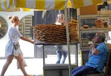 A vendor of local pastries waits for clients in central Athens, Greece, July 6, 2015. PHOTO BY REUTERS/Jean-Paul Pelissier