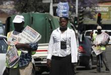 Hawkers sell newspapers and bottled water on the streets of Zimbabwe's capital Harare, September 17, 2015. PHOTO BY REUTERS/Philimon Bulawayo