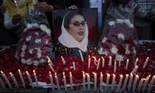 Supporters of Pakistan People's Party hold an image of Pakistan's former prime minister Benazir Bhutto during a candlelight vigil to commemorate her death anniversary in Lahore, December 26, 2011. PHOTO BY REUTERS/Mohsin Raza