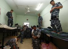 Volunteers, who have joined the Iraqi army to fight against militants of the Islamic State, formerly known as the Islamic State in Iraq and the Levant (ISIL), get dressed in their military attire in Baghdad