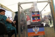 A voter casts a ballot inside a tent during the referendum on the status of Donetsk region in the eastern Ukrainian city of Donetsk