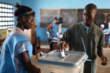 A voter casts his ballot at a polling station during Sierra Leone's general election in Freetown, Sierra Leone, March 7, 2018. PHOTO BY REUTERS/Olivia Acland