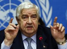 Syria's Foreign Minister Walid al-Moualem gestures as he addresses a news conference at the United Nations European headquarters in Geneva