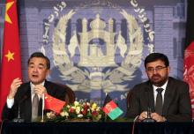 Chinese Foreign Minister Wang Yi (L) speaks as Afghanistan's Foreign Minister Zarar Ahmad Osmani looks on during a news conference in Kabul