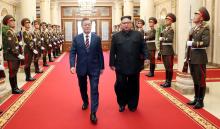 South Korean President Moon Jae-in is greeted by North Korean leader Kim Jong Un as he arrives at the headquarters of the Central Committee of the Workers' Party of Korea for their meeting in Pyongyang, North Korea, September 18, 2018. PHOTO BY REUTERS/Pyeongyang Press Corps