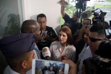 Marta de Martinelli, wife of former Panama president Ricardo Martinelli, speaks to an official while waiting for his extradition from U.S. outside the Panama Pacifico international airport in Panama City, Panama June 11, 2018. PHOTO BY REUTERS/Carlos Lemos