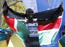 Wilson Kipsang of Kenya celebrates with his country's flag after winning the men's professional division of the 2014 New York City Marathon in Central Park in Manhattan, November 2, 2014. PHOTO BY REUTERS/Mike Segar