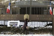 A woman walks past a French Embassy in a file photo. PHOTO BY REUTERS/Gary Cameron