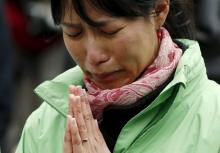 A participant observes a moment of silence at 2:46 p.m. (0546 GMT), the time when the magnitude 9.0 earthquake struck off Japan's coast in 2011, during a rally in Tokyo March 11, 2016, to mark the fifth-year anniversary of the earthquake and tsunami that killed thousands and set off a nuclear crisis. PHOTO BY REUTERS/Toru Hanai