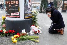 A woman prays near the area where a truck which ploughed into a crowded Christmas market in the German capital last night in Berlin. PHOTO BY REUTERS/Pawel Kopczynski