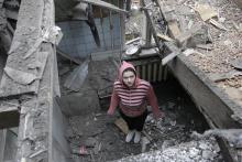 A woman stands in her house, which was damaged by recent shelling, in central Donetsk, eastern Ukraine, February 2, 2015. PHOTO BY REUTERS/Alexander Ermochenko