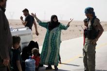 A Syrian woman reacts after she removes the niqab as she arrives with her family at the Syrian Democratic Forces (SDF) check point in the eastern of Deir al Zor, Syria, September 12, 2017. PHOTO BY REUTERS/Rodi Said
