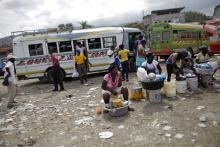 Women offer food for sale at a bus station in Port-au-Prince, February 8, 2015. PHOTO BY REUTERS/Andres Martinez Casares