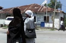 Two muslim women walk past offices of the Civic United Front on Tanzania's Pemba in a file photo. PHOTO BY REUTERS