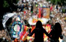 Two women are silhouetted as revellers fill the streets of London's Notting Hill during the annual carnival, August 29, 2005. Up to one million people were expected on Monday to throng London's streets for the Notting Hill Carnival, one of the world's biggest street parties. PHOTO BY REUTERS/Stephen Hird SH/ASA