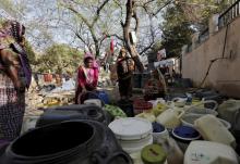 Women fill water in their containers from a municipal tap in New Delhi. India deployed thousands of troops in Haryana to quell protests that have severely hit water supplies to Delhi. February 21, 2016. PHOTO BY REUTERS/Anindito Mukherjee