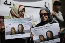 Women hold posters of Frenchwoman, Isabelle Prime (R) and her Yemeni translator Shereen Makawi during a protest to demand their release in Sanaa, March 9, 2015. PHOTO BY REUTERS/Khaled Abdullah