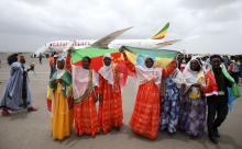 Passengers carry the Ethiopian and Eritrean national flags as they celebrate after arriving at the Asmara International Airport aboard an Ethiopian Airlines flight in Asmara, Eritrea July 18, 2018. PHOTO BY REUTERS/Tiksa Negeri