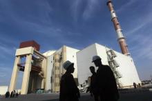 Iranian workers stand in front of the Bushehr nuclear power plant, about 1,200 km (746 miles) south of Tehran