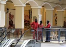 Workers stand in a section of the reopened Westgate shopping mall, which was closed in the aftermath of an attack by militant gunmen in September 2013 that killed 67 people and injured many more, in capital Nairobi, July 14, 2015. PHOTO BY REUTERS/Noor Khamis