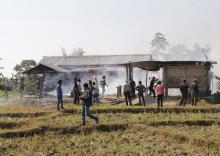 Tribal plantation workers burn houses belonging to indigenous Bodo tribesmen after ethnic clashes in Balijuri village, in Sonitpur district in the northeastern Indian state of Assam, December 24, 2014. PHOTO BY REUTERS/Stringer