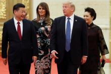 U.S. President Donald Trump and first lady Melania arrive for the state dinner with China's President Xi Jinping and China's first lady Peng Liyuan at the Great Hall of the People in Beijing, China, November 9, 2017. PHOTO BY REUTERS/Jonathan Ernst
