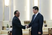Chinese President Xi Jinping (R) shakes hands with India's National Security Adviser Ajit Doval at the Great Hall of the People in Beijing, September 9, 2014. PHOTO BY REUTERS/Lintao Zhang