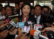 Ousted former Prime Minister Yingluck Shinawatra speaks to the media as she arrives at Parliament before the National Legislative Assembly meeting in Bangkok, January 9, 2015. PHOTO BY REUTERS/Chaiwat Subprasom
