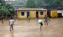 Youths play soccer in the rain at the Ndako ya Biso (Our House) refugee centre for street children in the Democratic Republic of Congo's capital Kinshasa, February 5, 2016. PHOTO BY REUTERS/Aaron Ross