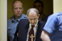 Zdravko Tolimir, a Bosnian Serb general convicted of genocide in the 1995 Srebrenica massacre, is escorted by U.N. security guards as he arrives in the courtroom of the the Yugoslav war crimes tribunal who delivered its judgment in his appeal case in The Hague, Netherlands, Wednesday, April 8, 2015. PHOTO BY REUTERS/Peter Dejong
