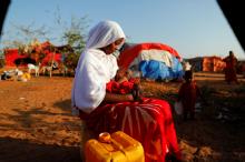 Zeinab, 14, sits as she holds her nephew at a camp for internally displaced people from drought-hit areas in Dollow, Somalia. PHOTO BY REUTERS/Zohra Bensemra