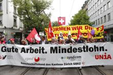 Protesters walk in downtown Zurich during a May Day demonstration