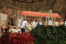 Men wait to buy food for Ramadan at Khartoum's central food market July 18, 2012. REUTERS/ Mohamed Nureldin Abdallah